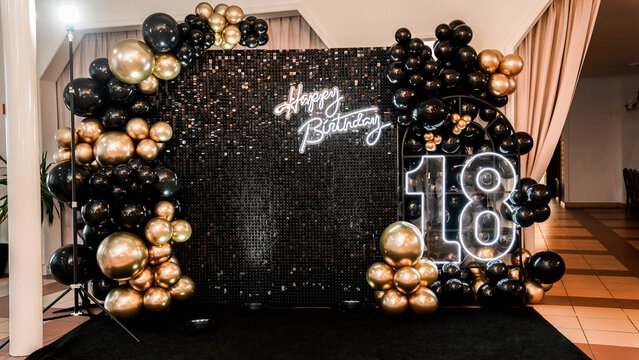 decor with balloons of gold and black collors , neons text birthday party. 18th birthday