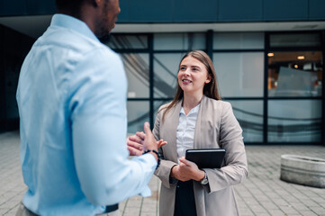 Businesspeople discussing work outside office building