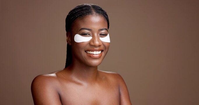 Woman, eye patch and face in studio for dark circles, cosmetics or hydration on background. African girl, model and smile with space for dermatology, skincare and benefits for beauty in Nigeria