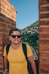 Man at fortress ruins of the historical Red Tower in Alanya Castle, the famous touristic place.