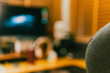 Modern cinematic desk setup with triple monitor, gaming chair, ambient light, and cozy atmosphere for work or gaming.