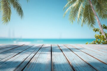 Fototapeta premium A weathered light-blue wood plank surface extends towards a blurred tropical beach scene, framed by palm fronds under a clear sky