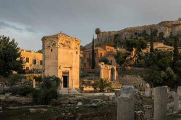 The Horologion of Andronikos Cyrrhestes, an ancient octagonal tower used as a weather station with sundials & a wind vane, in Athens Greece. The setting sun is lighting up the ancient structure