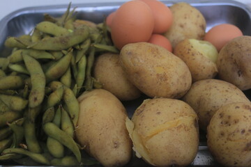 Edamame, eggs and potatoes that have been boiled are placed in one container and will be processed...