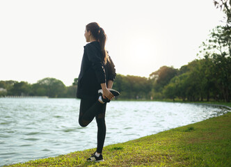 A woman getting ready to run and stretching, exercising before running.