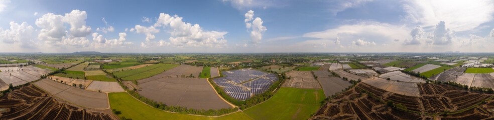 Aerial panoramic view of a solar power plant, also known as a solar park, is a large-scale photovoltaic (PV) system designed to supply commercial electricity to the electrical grid.
