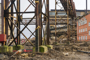 Abandoned industrial structure with rusted steel framework, construction site in urban redevelopment