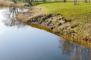 Abrasion or coastal erosion of the city park canal bank due to improper bank reinforcement