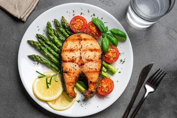 Grilled salmon steak with roasted green asparagus and vegetables