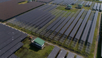 An aerial view of a solar power plant, also known as a solar park, is a large-scale photovoltaic (PV) system designed to supply commercial electricity to the grid.	