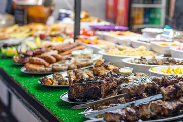 Street food meat vegetables salads on the counter