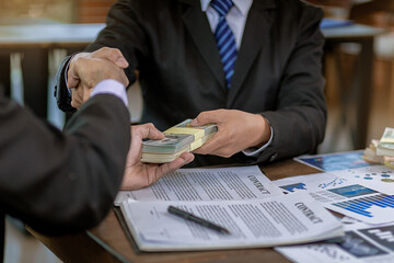 Businessman handshake at business meeting after negotiations with business partners and making investment. Selected focus