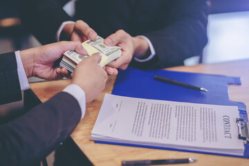 Banker offering loan money for customer and signing a loan contract. Selected focus