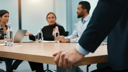Business meeting with diverse professionals discussing around table - Powered by Adobe