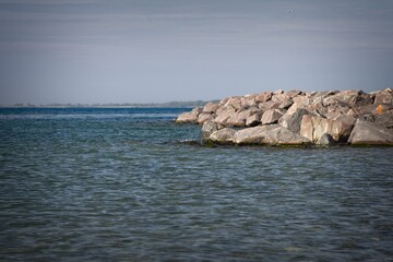Tranquil Rocky Shoreline by Calm Waters