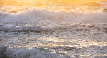 Ocean waves crashing on shore in early morning light