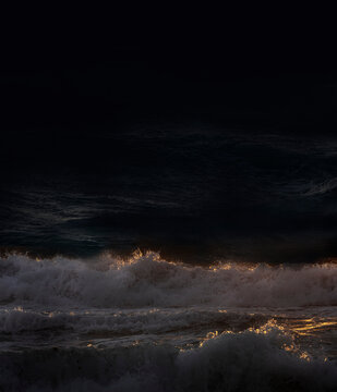 Ocean waves crashing on shore at night