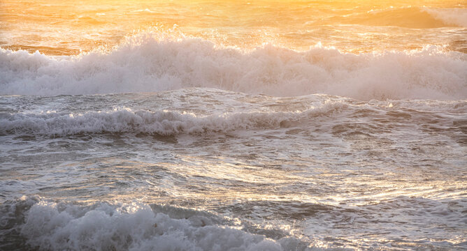 Ocean waves crashing on shore in early morning light - Powered by Adobe