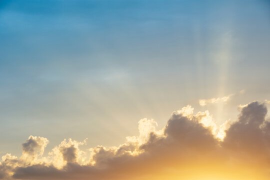 Setting sun shining through clouds