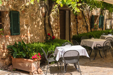 Sunny And Shady Tables At An Idyllic Restaurant
