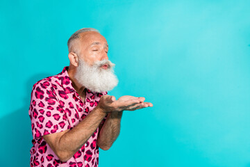 Portrait of funky aged man send air kiss empty space wear leopard print costume isolated on...