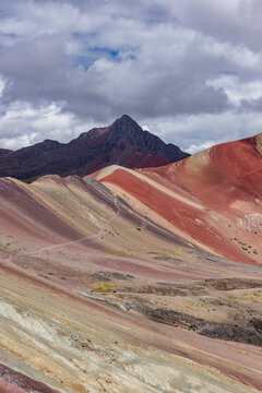 White puffy clouds over Rainbow Mountain