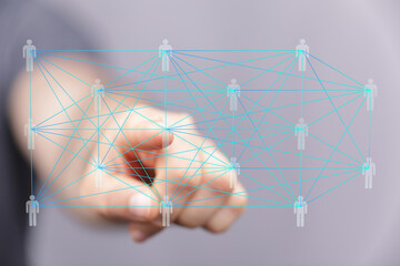 Abstract image of a hand interacting with a digital network of interconnected people, representing...
