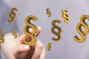 3D golden paragraph symbols hover over a hand.  Perfect for legal, law, or justice concepts.