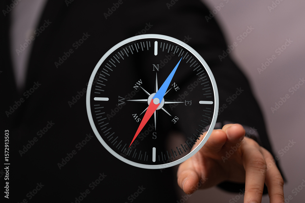 Poster conceptual image of a businessman using a digital compass for navigation and direction.