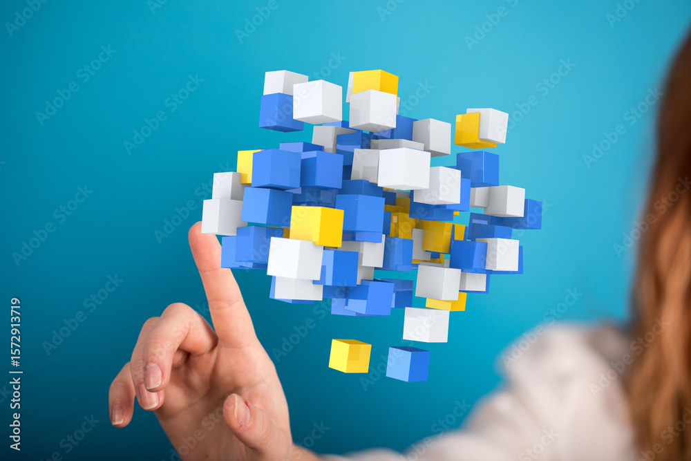 Poster abstract image of a hand interacting with a cloud of colorful data cubes, representing data analysis