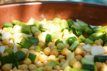 A close-up of a traditional Cretan dish made with chickpeas and leeks, showcasing its rustic texture, earthy tones, and home-cooked authenticity.
