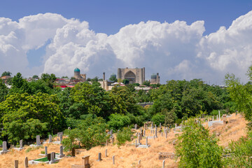 Cemetery near Shah-i-Zinda which is a necropolis in the north-eastern part of Samarkand and Bibi-Khanym Mosque in the background  Samarkand, Uzbekistan