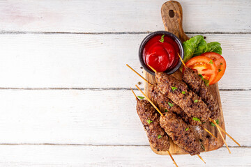 Shish kebab on stick, made from ground beef meat. Lula kebab, traditional Caucasian dish, with...