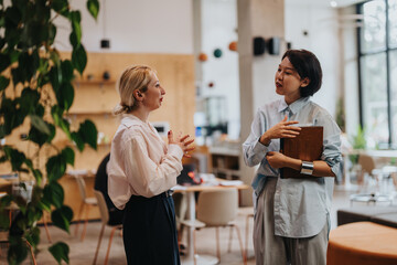Two people share ideas in a stylish and naturally lit co working environment. The collaborative...