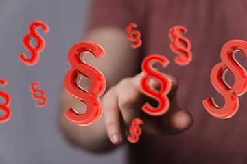 Abstract image of a hand interacting with floating 3D paragraph symbols.  Perfect for legal, law,...