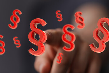 Abstract image of red paragraph symbols floating, representing digital law or legal tech.