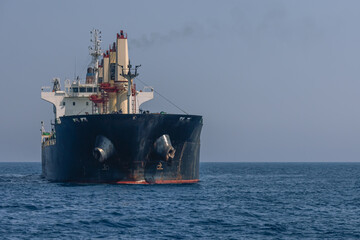 A large marine vessel transports cargo on the high seas. Navigation of large ships. A large cargo...