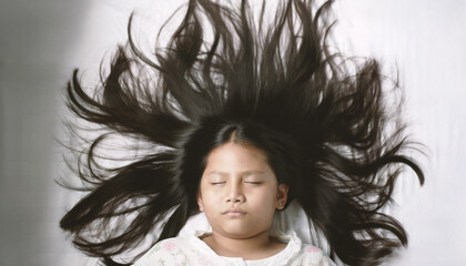 A girl is sleeping on a bed with plain white sheets in a bedroom at home. Cute close-up face Sleep...