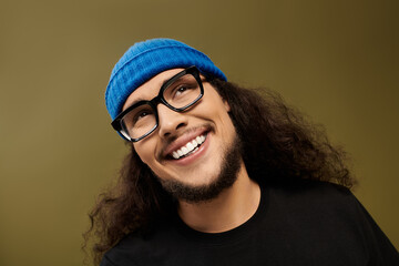 Charming young man with beard and artistic style exudes confidence and warmth