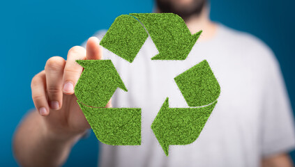 Green grass recycling symbol, sustainable eco concept.  Man interacts with digital eco-friendly...