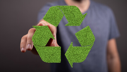 Person interacting with a green recycle symbol. Eco-friendly concept.