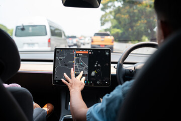 Woman drive EV car use GPS navigator on road