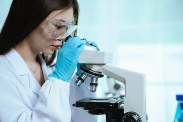 Scientist analyzes biological samples using advanced laboratory equipment for medical research,...