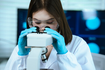 Scientist analyzes biological samples using advanced laboratory equipment for medical research,...