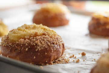 Appetizing fresh sweet pastries on a baking sheet close-up in a bakery