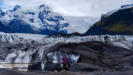 Majestic Svinafellsjokull Glacier showcases intricate ice formations and rugged terrain against a...