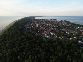 Spectacular bird's eye view of historic seaside town with colorful rooftops surrounded by dense...