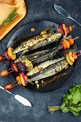 Fish and vegetable skewer in barbecue grill.