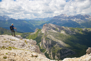 Hiker enjoys the view from Lagazuoi mountain over the italian Dolomites.