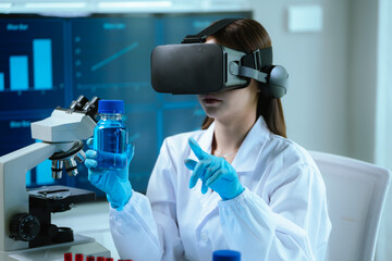 A female scientist wearing virtual reality goggles explores interactive data and medical...